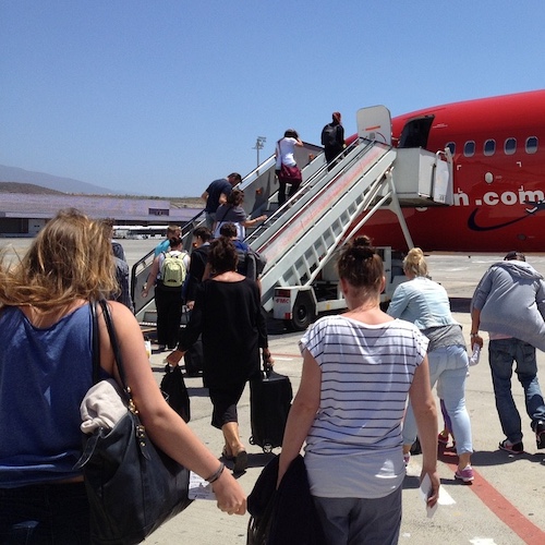 Anxiety free passengers boarding a plane on holiday